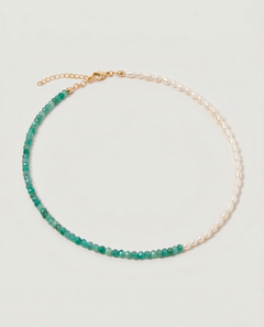 green aventurine and pearl beaded necklace in gold, with one half strung with pearls and the other half with faceted green aventurine beads in fresh green tones.