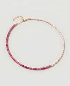  Rose quartz and pearl beaded necklace in gold, with one half strung with imitation pearl rice beads and the other half with faceted rose quartz beads graduating from soft blush to deep pink.