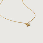 A gold-plated necklace with a small starfish pendant on a twisted chain.