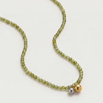 Olive green beaded necklace in gold, with green cubic zirconia beads and a two-tone pendant 