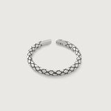 A sterling silver ring with an intricate scale-like pattern, featuring an open-ended design for adjustable sizing.