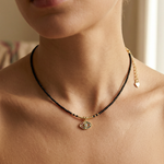 close up of a female wearing a devil eye pendant necklace