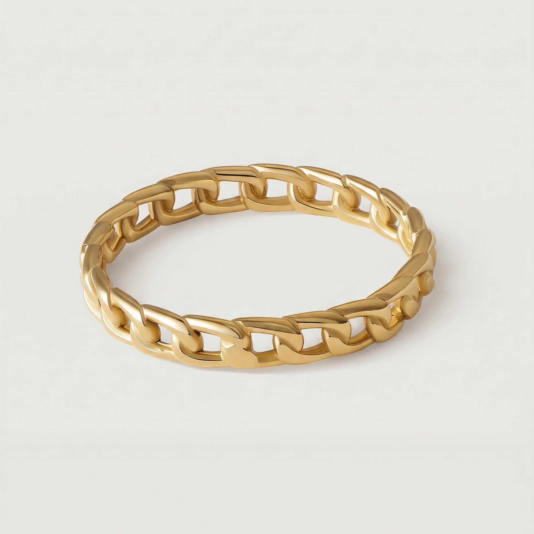 A gold-plated ring with a chain-inspired design, displaying a sleek, polished surface.