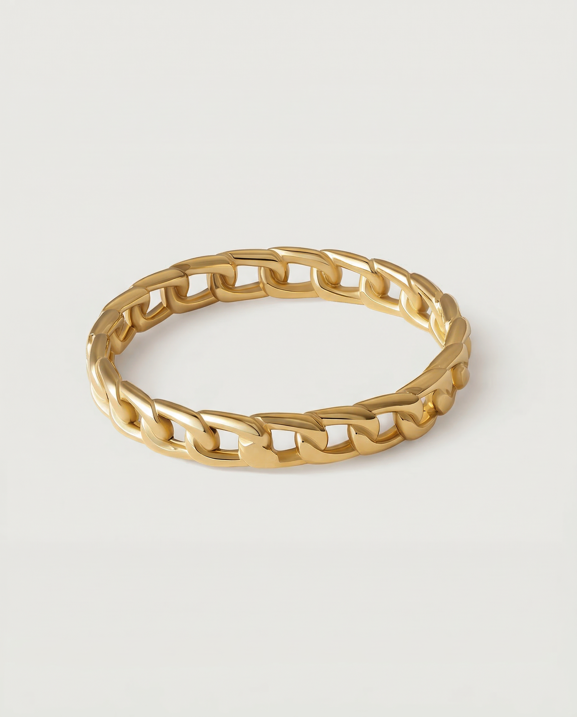 A gold-plated ring with a chain-inspired design, displaying a sleek, polished surface.