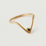 A gold-plated ring with an angular design and a black crystal set in a V-formation on a white background.