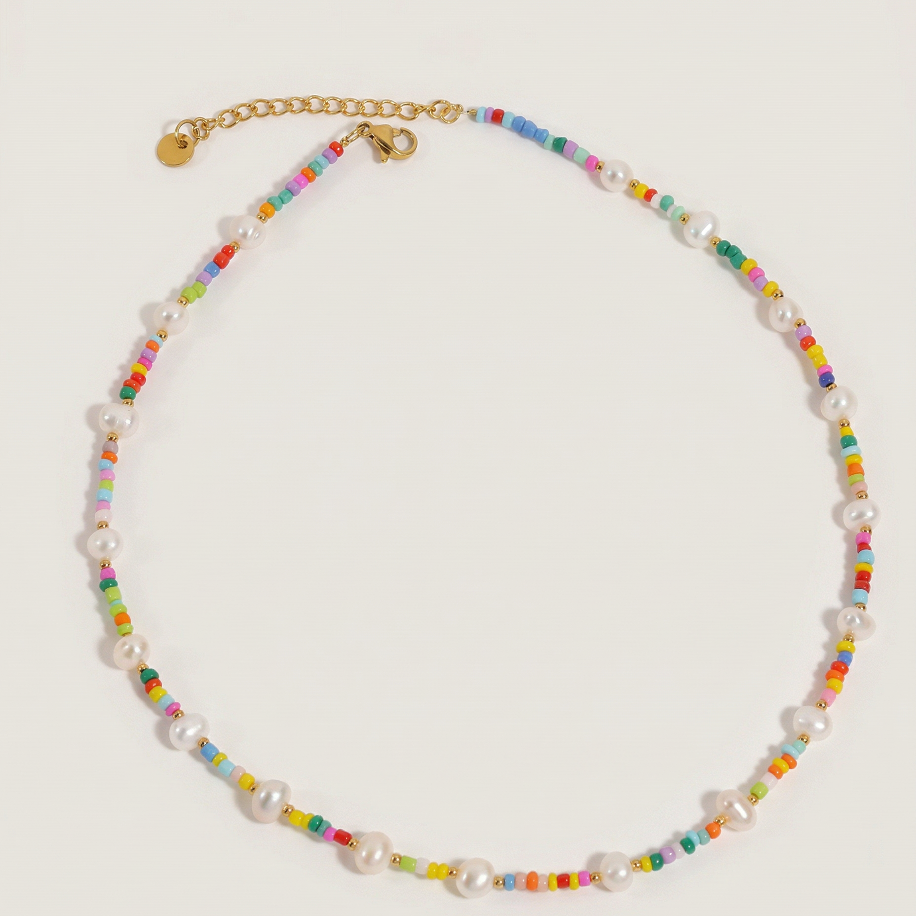 Necklace with multicolored beads and pearl-like elements on a light gray background