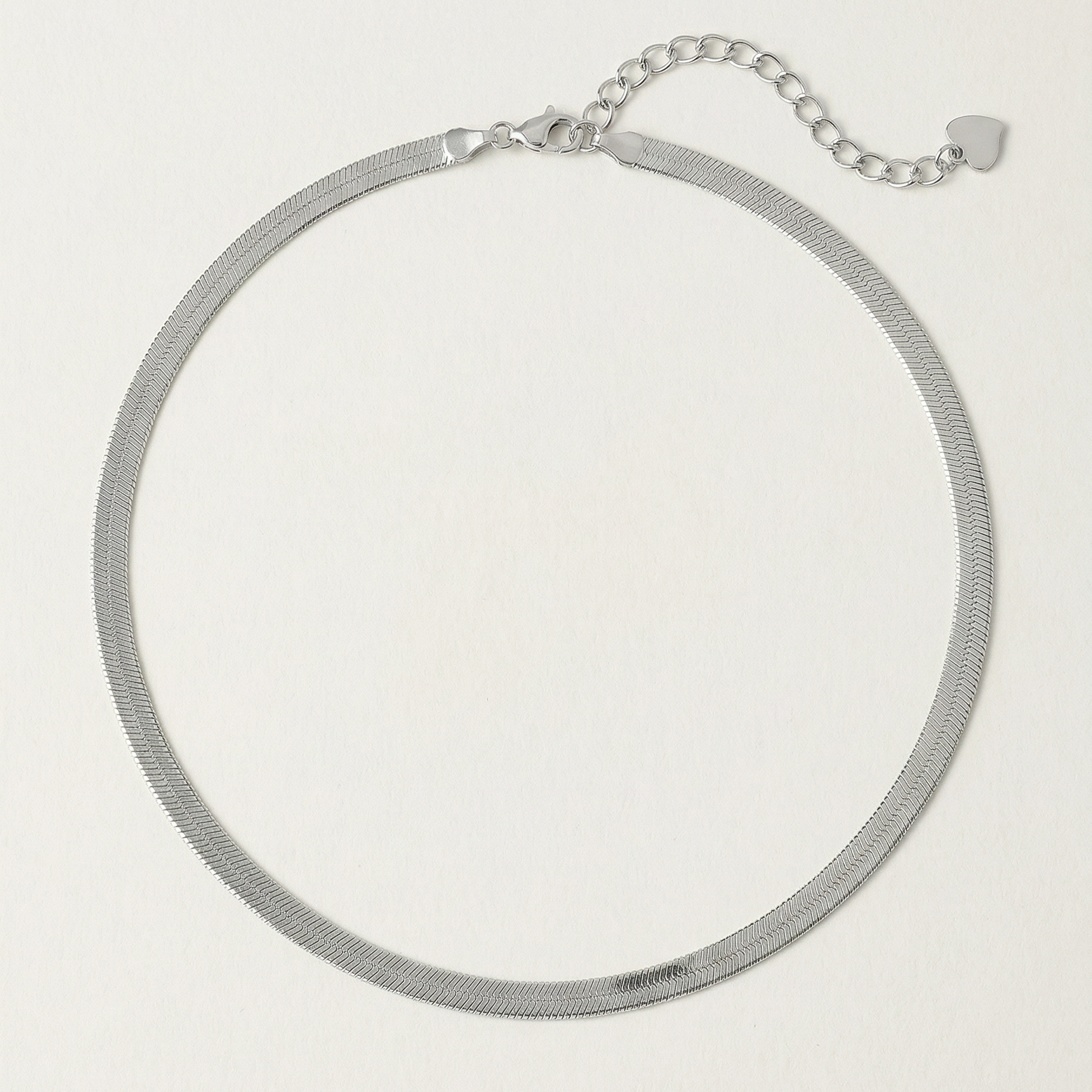 A  sterling silver snake chain necklace with an adjustable length and a heart charm