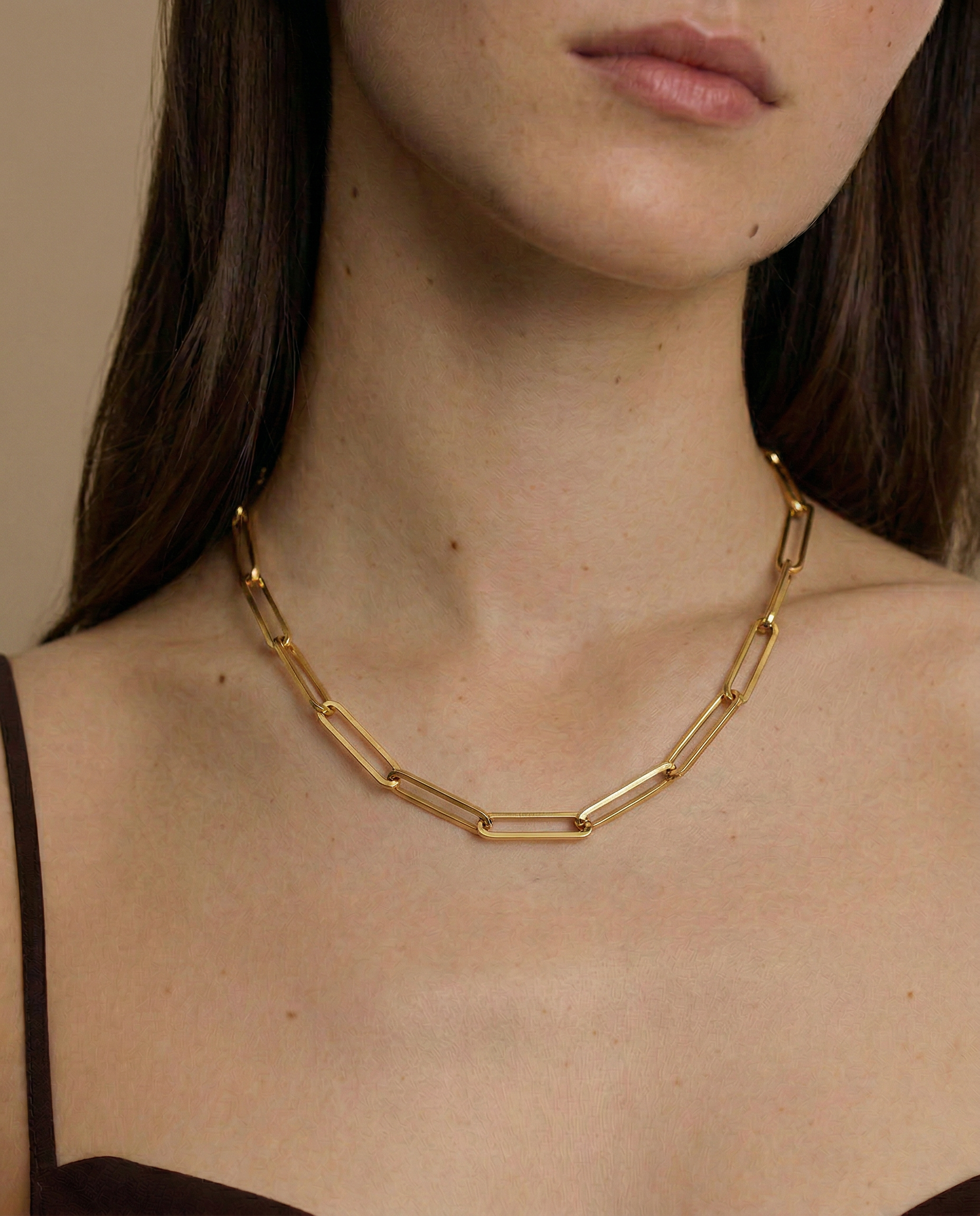 model wearing a gold paperclip chain necklace