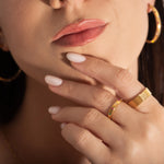 model wearing a pave ring and a coloured crystals band ring