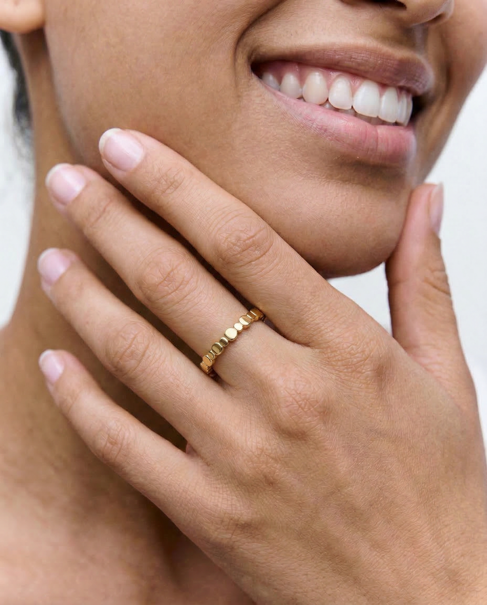 close up of a model wearing a delicate 2mm gold plated ring