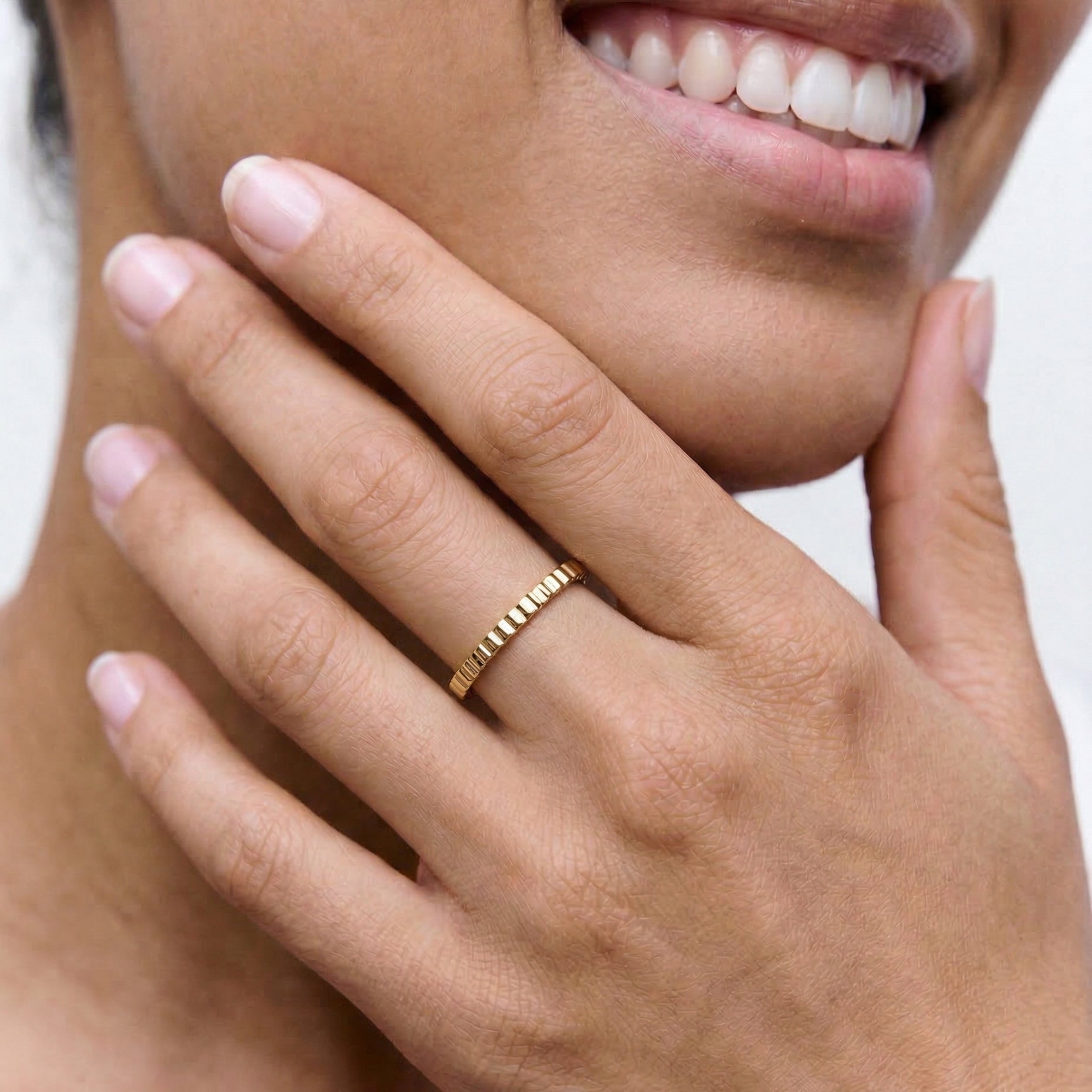 close up of a model wearing a 18k gold plated 2mm ring