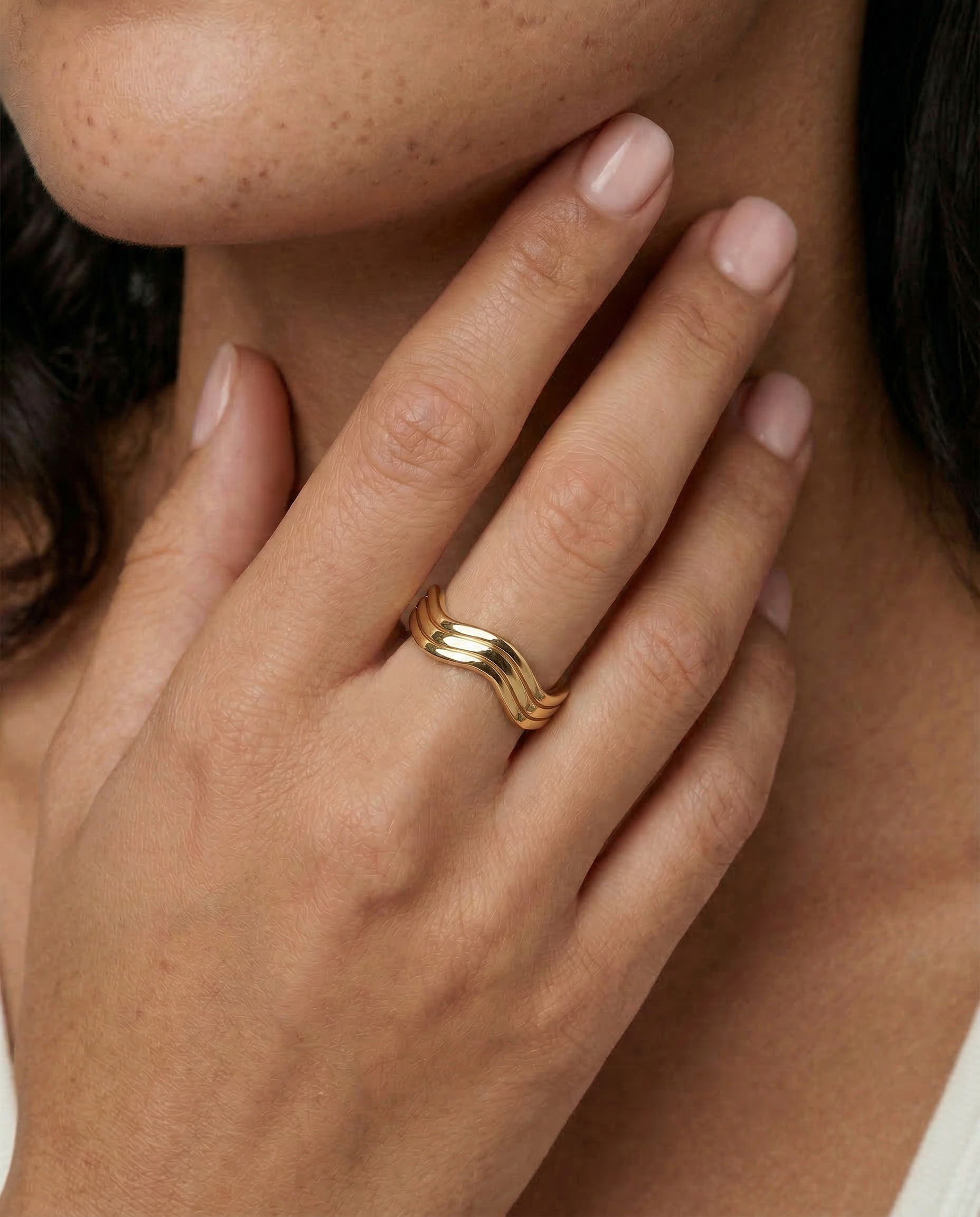model wearing a wavy gold ring