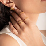 close up of a model wearing multiple 2mm gold plated rings