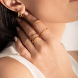 close up of a model wearing multiple 2mm gold plated rings