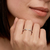 close-up of a model wearing a sterling silver open cuff ring with two tiny CZ stones at each end, by kaleya studio