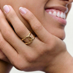 close up of a model wearing bold statement gold plated ring