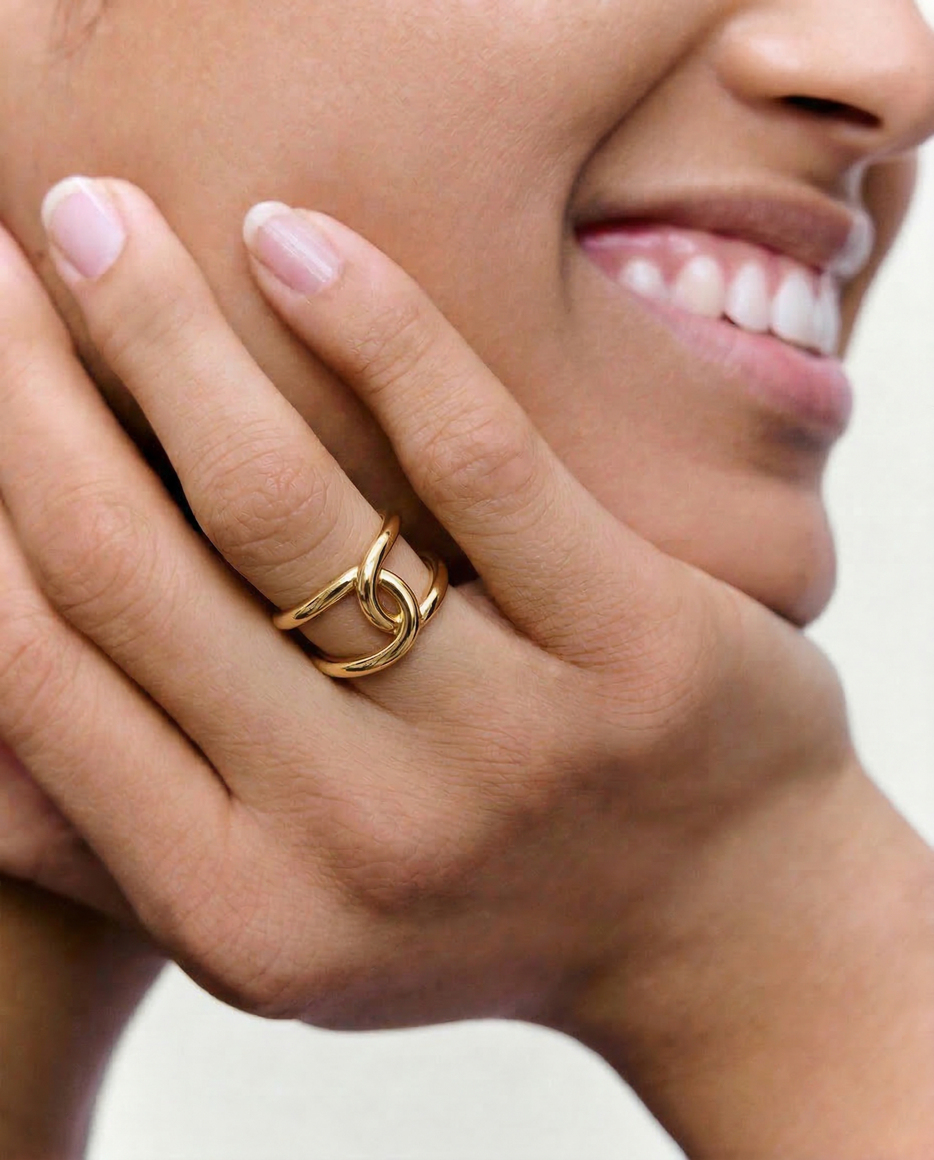 close up of a model wearing bold statement gold plated ring