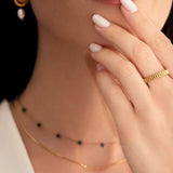 model wearing a gold-plated band ring with fluted edges