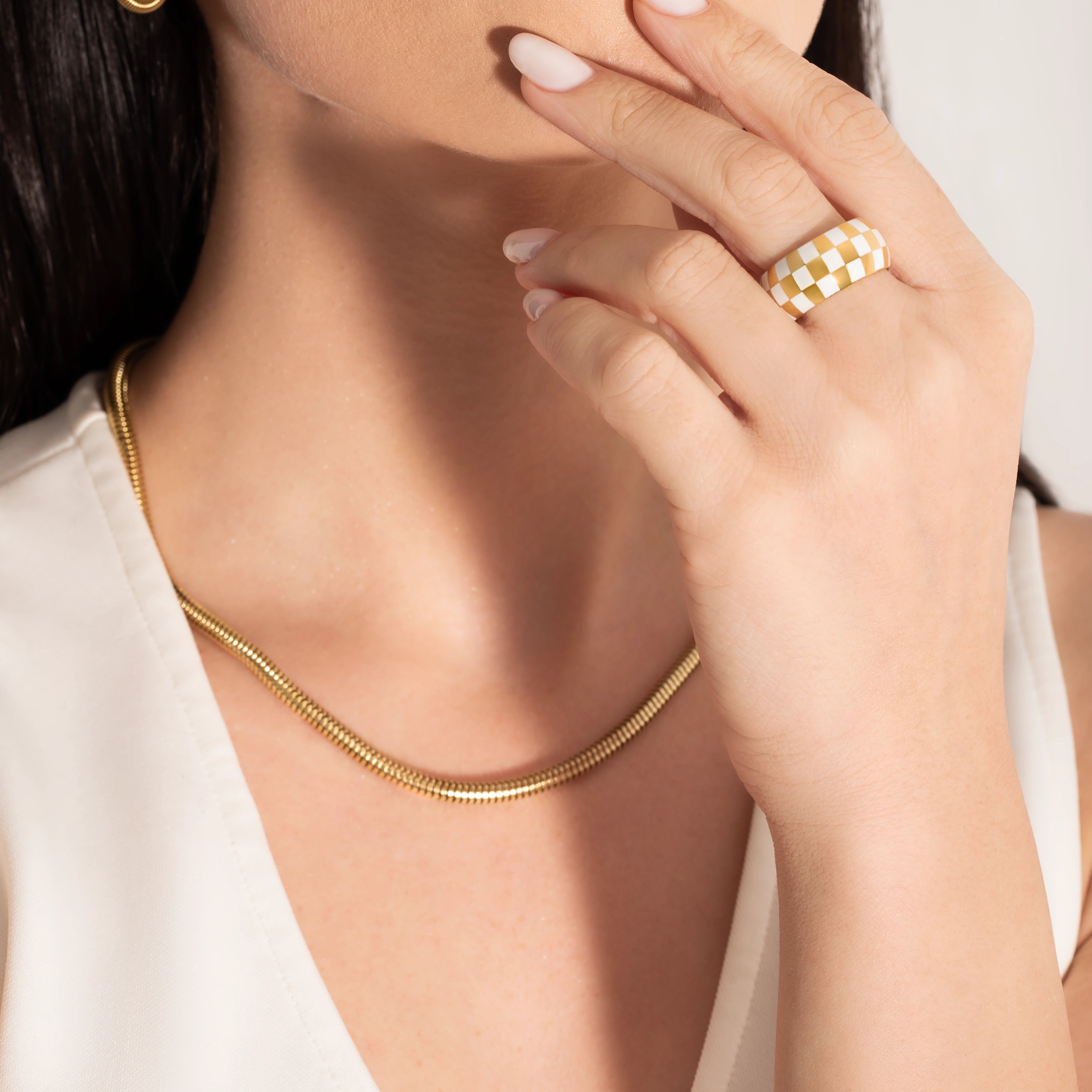 model wearing a big statement checkers board ring 