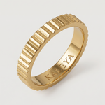 A gold-plated band ring with fluted edges, displayed against a white background