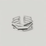 rotating video of a silver ring with a hexagonal design featuring geometric flowing lines and black crystal accents on the edges
