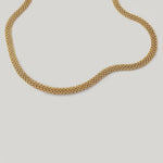 video of a gold-plated metallic mesh necklace with a fluid ribbon design
