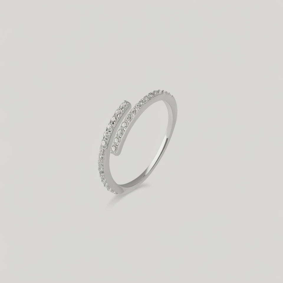 rotating video of a silver ring with an open spiral design adorned with sparkling cubic zirconia stones