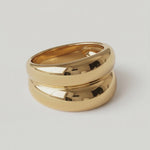 rotating video of a gold-plated ring with a smooth, curved design 