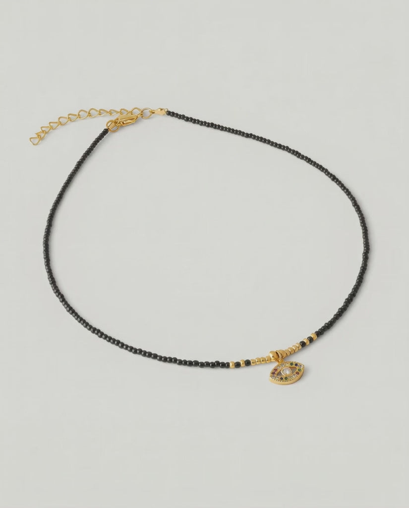 video of A gold-plated choker necklace with black beads and a crystal-embellished evil eye pendant