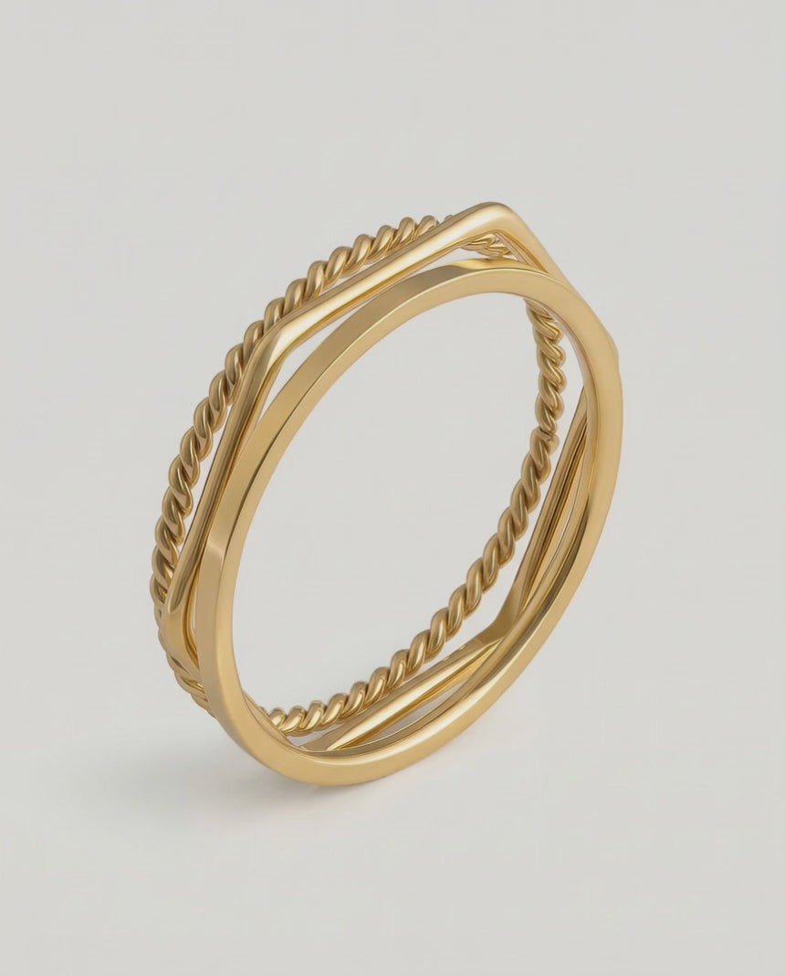 video of three gold-plated stainless steel stacking rings with a twisted design, polished finish