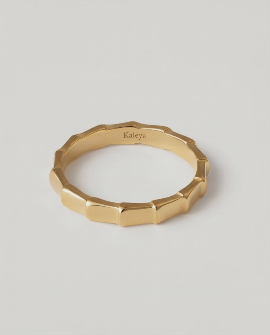 360 rotating video of a gold-plated ring with a textured surface designed to mimic bamboo segments