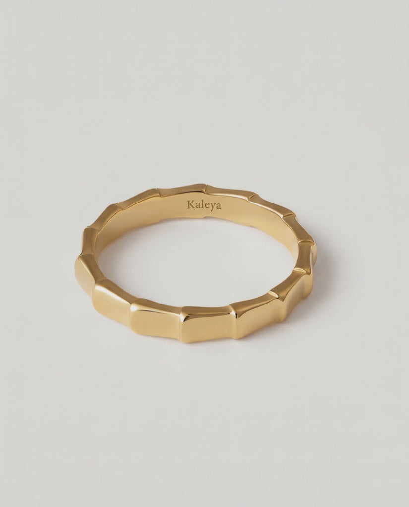 360 rotating video of a gold-plated ring with a textured surface designed to mimic bamboo segments