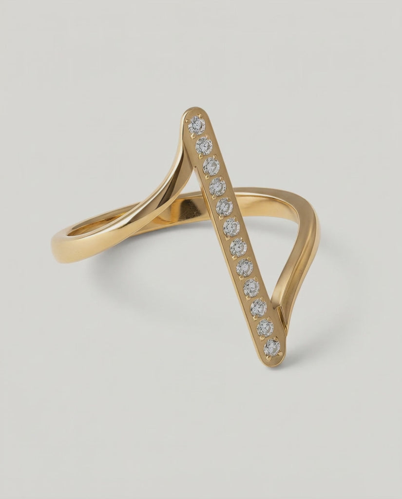 360 rotating video of a contemporary gold-plated ring with an asymmetric design featuring a sleek bar adorned with a line of sparkling stones