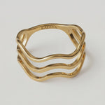 360 rotating video of a gold-plated ring with a wave design open band
