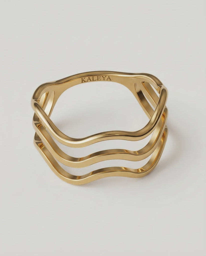 360 rotating video of a gold-plated ring with a wave design open band