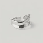 rotating video of a sterling silver, asymmetrical, open-ended ring with a smooth, polished surface.