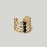rotating video of a gold-plated cuff ring with five bands and three onyx stones in the center