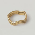 rotating video of a wavy gold ring