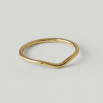 360 video of a gold-plated metal ring with a fluid, asymmetrical wave design