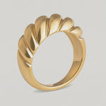 rotating video of a gold-plated stainless steel ring with a textured, wave-like design