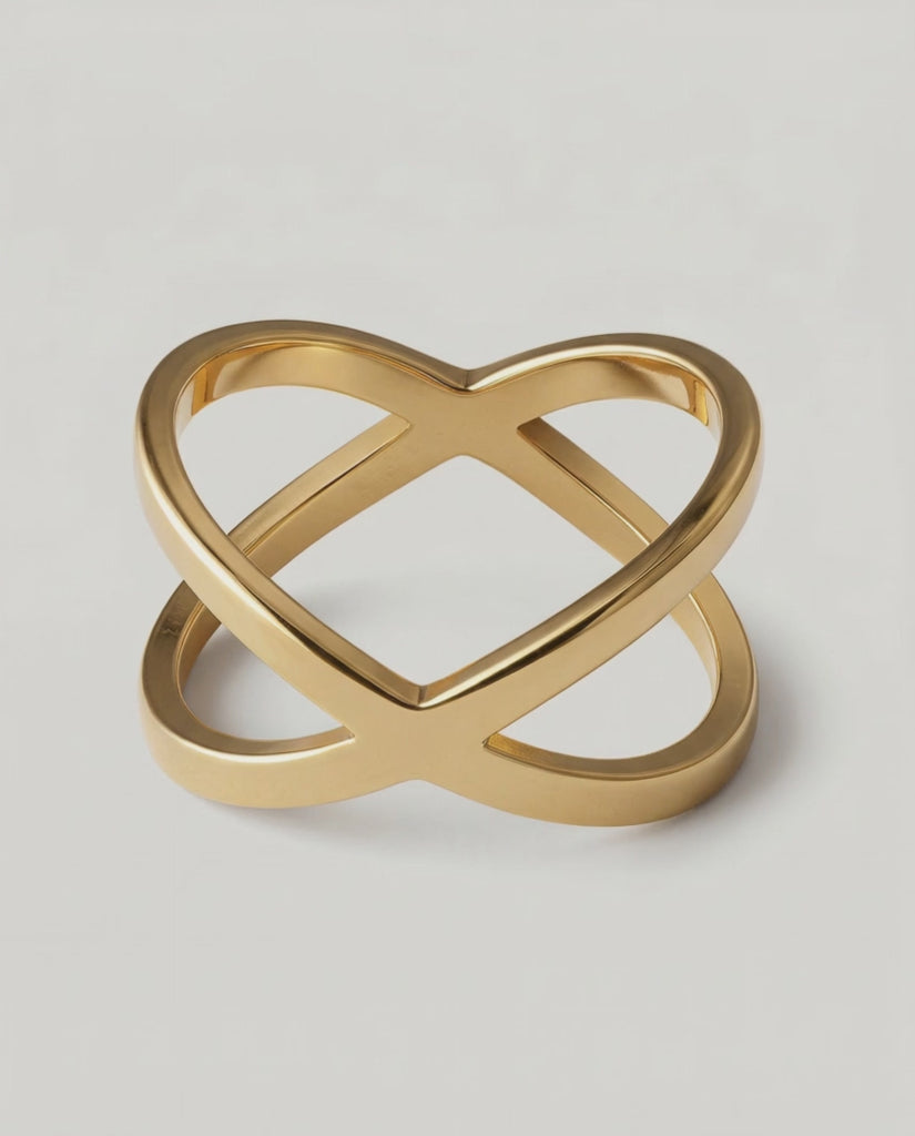 rotating video of a gold-plated ring with two slender bands that intersect creating a modern X-shape design