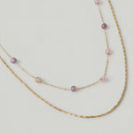 video of a two-strand gold-plated necklace with delicate rose quartz beads and a sleek snake chain.