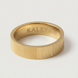 A gold plated band ring with a ribbed texture, displayed on a white background.