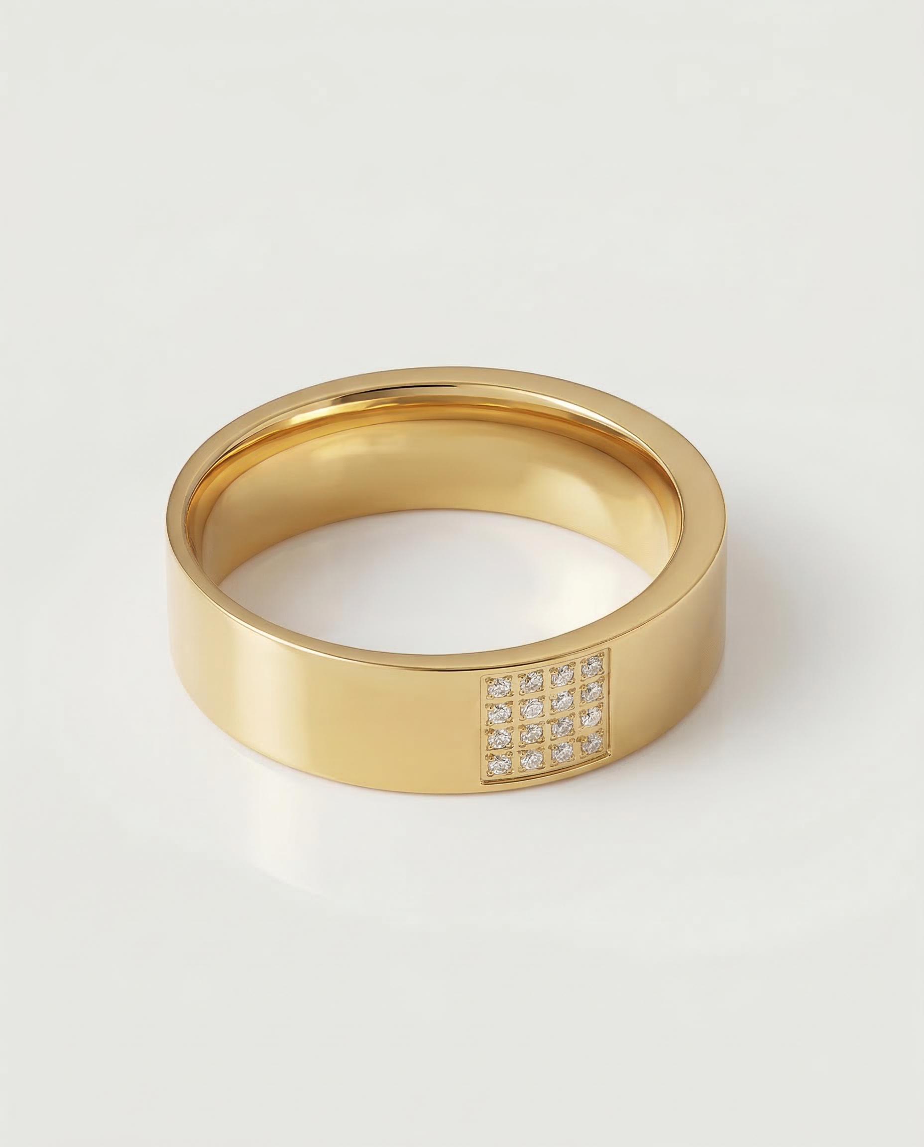 A gold-plated stainless steel ring with a polished finish and a section of the band adorned with pavé-set stones.