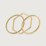 Three gold-plated stainless steel stacking rings with a twisted design, polished finish