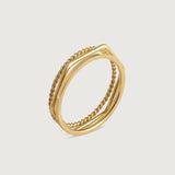 Three gold-plated stainless steel stacking rings with a twisted design, polished finish